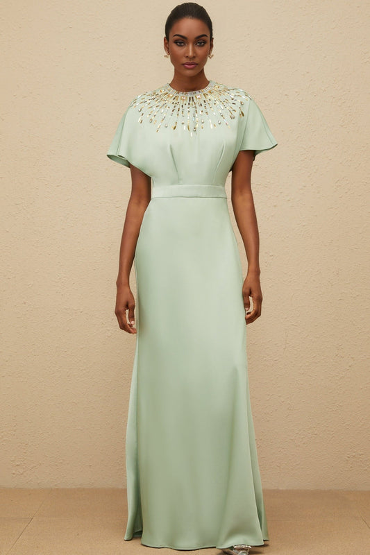 Green satin maxi dress with sequin, crystal, and bead embellishments, cinched waist, and open back