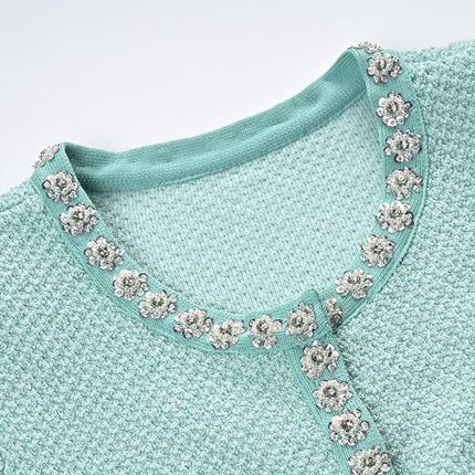 Green textured fabric dress with decorative buttons and pockets