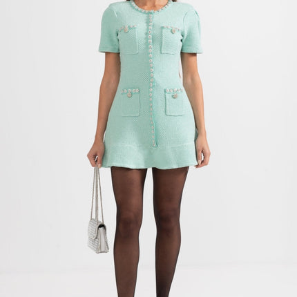 Green textured fabric dress with decorative buttons and pockets