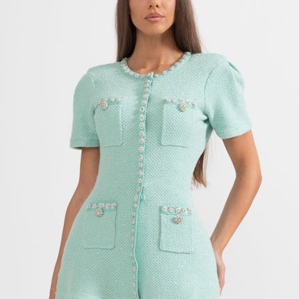 Green textured fabric flared skirt with decorative buttons and pockets