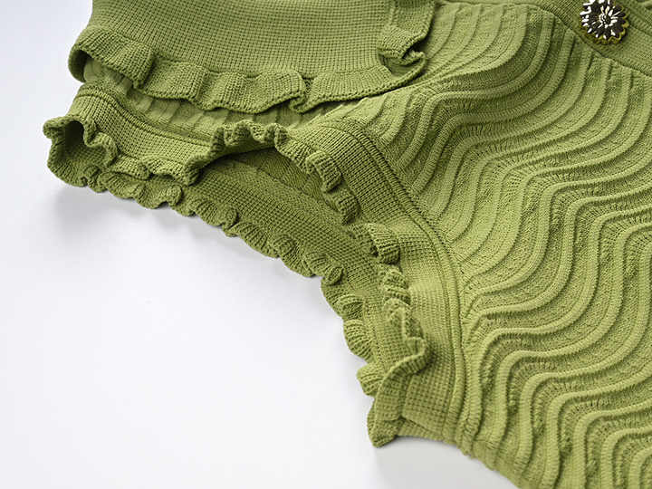 Green textured wave pattern sleeveless top with ruffled edges