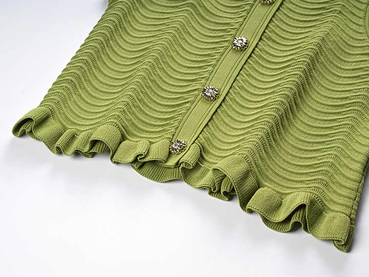 Green textured wave pattern sleeveless top with ruffled edges