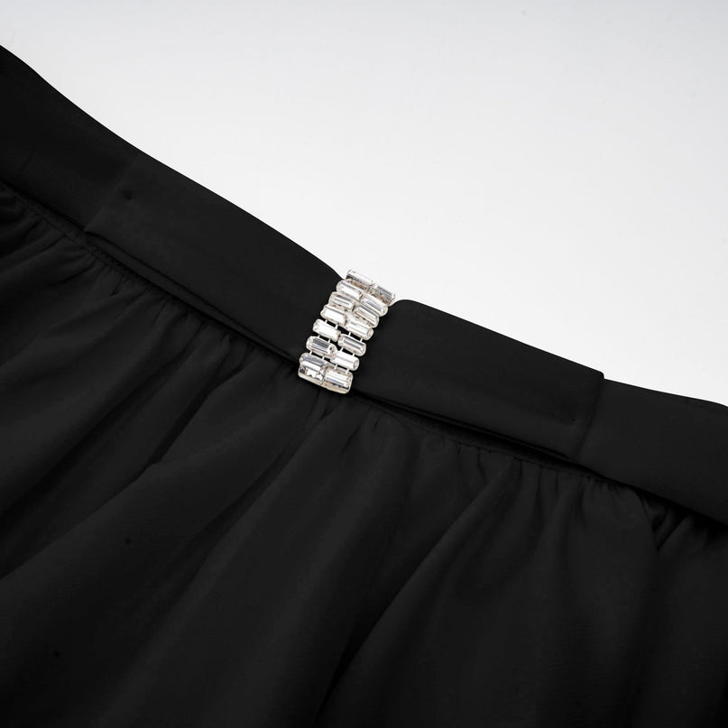 Heres a simple alt text for the product image based on the given title

Woman wearing black asymmetric tulle blouse and matching skirt set named Andrea