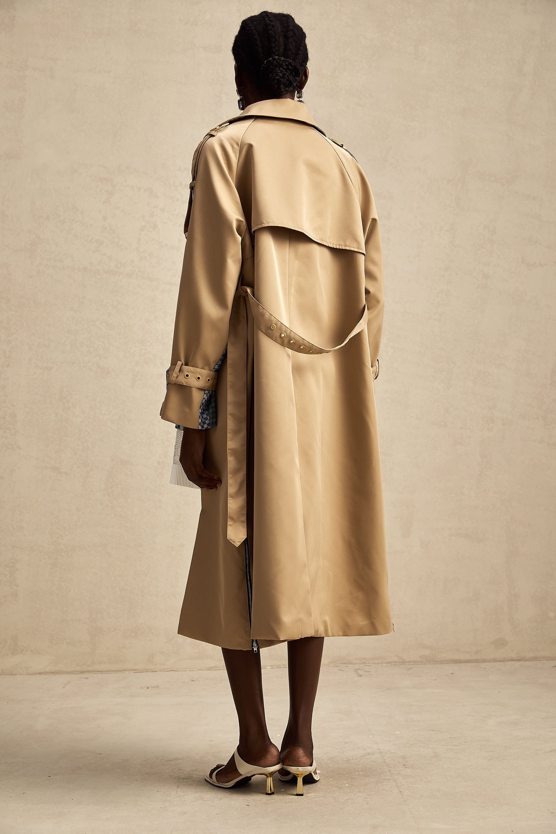 Heres a simple alt text for the product image based on the title

Woman wearing long beige trench coat with contrasting dark trim and belt tied at waist featuring allover print pattern