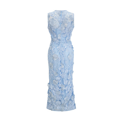 Herta blue dress with floral appliques reaching mid calf length on model against plain background