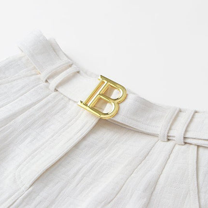High-waisted tailored shorts in crisp white with signature buckle detail
