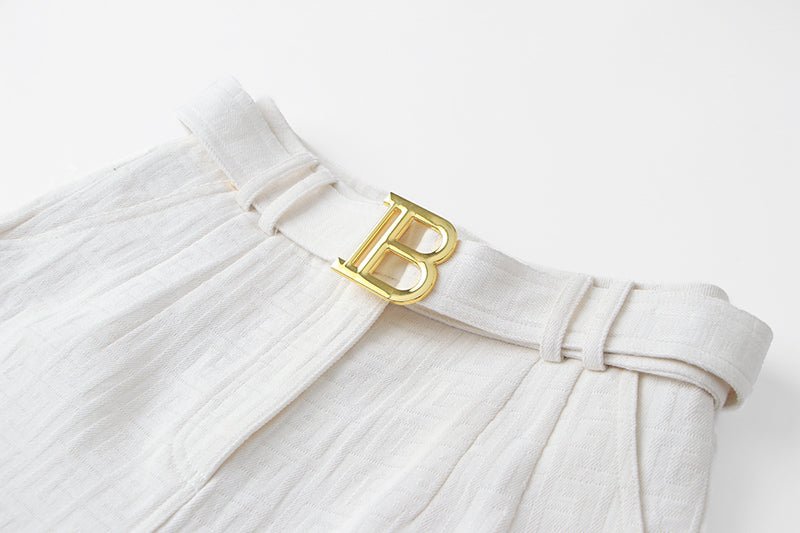 High-waisted tailored shorts in crisp white with signature buckle detail