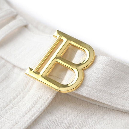 High-waisted tailored white shorts with buckle detail