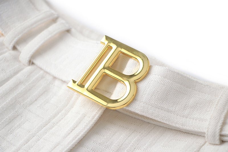 High-waisted tailored white shorts with buckle detail