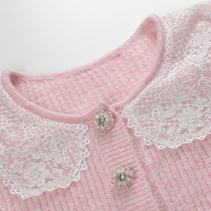 Pastel pink knit cardigan with lace collar and crystal buttons paired with a matching flared skirt