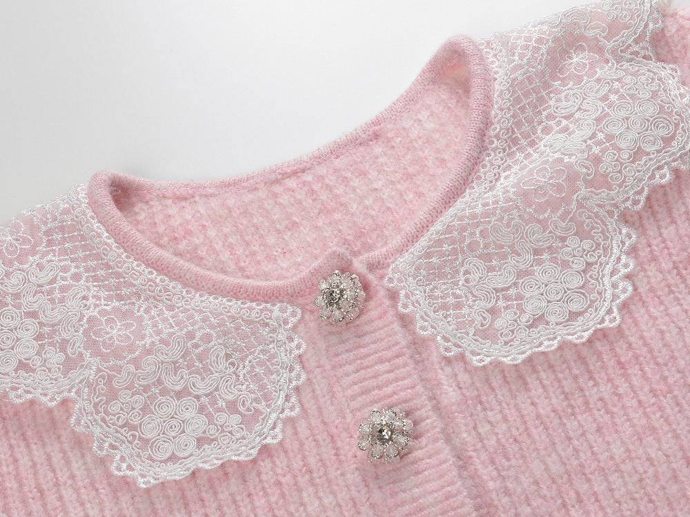 Pastel pink knit cardigan with lace collar and crystal buttons paired with a matching flared skirt