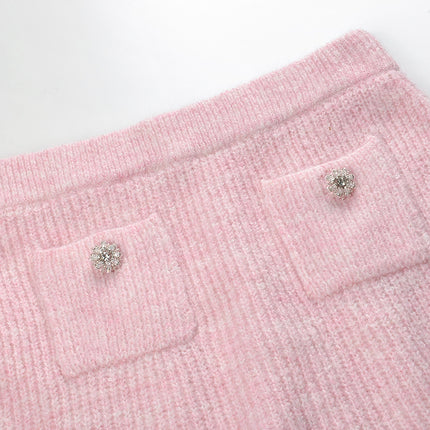 Pastel pink knit cardigan with lace collar and crystal buttons paired with a matching flared skirt
