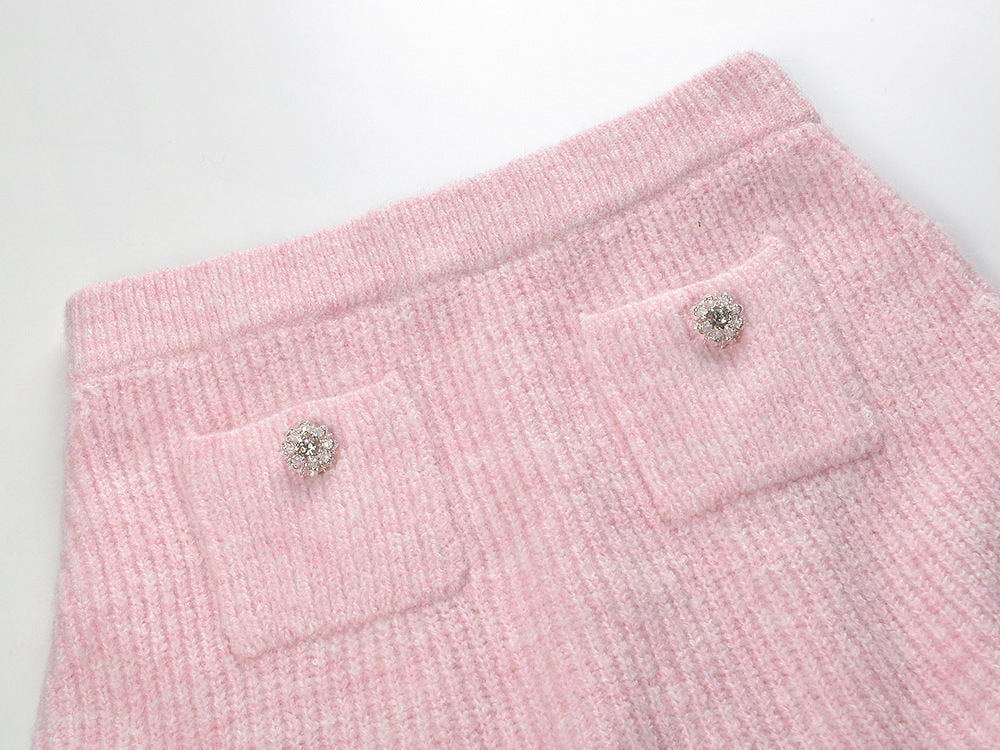 Pastel pink knit cardigan with lace collar and crystal buttons paired with a matching flared skirt