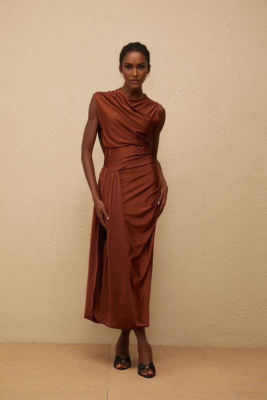 Ivanka Maxi Dress in mesmerizing brown with crew neck, fitted waistline, ruched detailing, asymmetrical design, and side slit for modern elegance and convenience