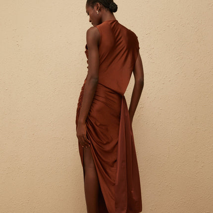 Ivanka Maxi Dress in mesmerizing brown with crew neck, fitted waistline, ruched detailing, asymmetrical design, and side slit for modern elegance and convenience