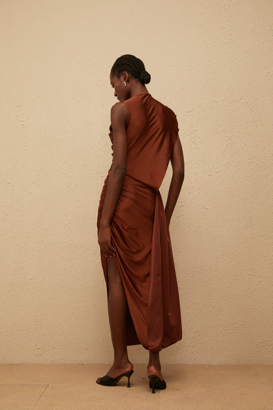 Ivanka Maxi Dress in mesmerizing brown with crew neck, fitted waistline, ruched detailing, asymmetrical design, and side slit for modern elegance and convenience