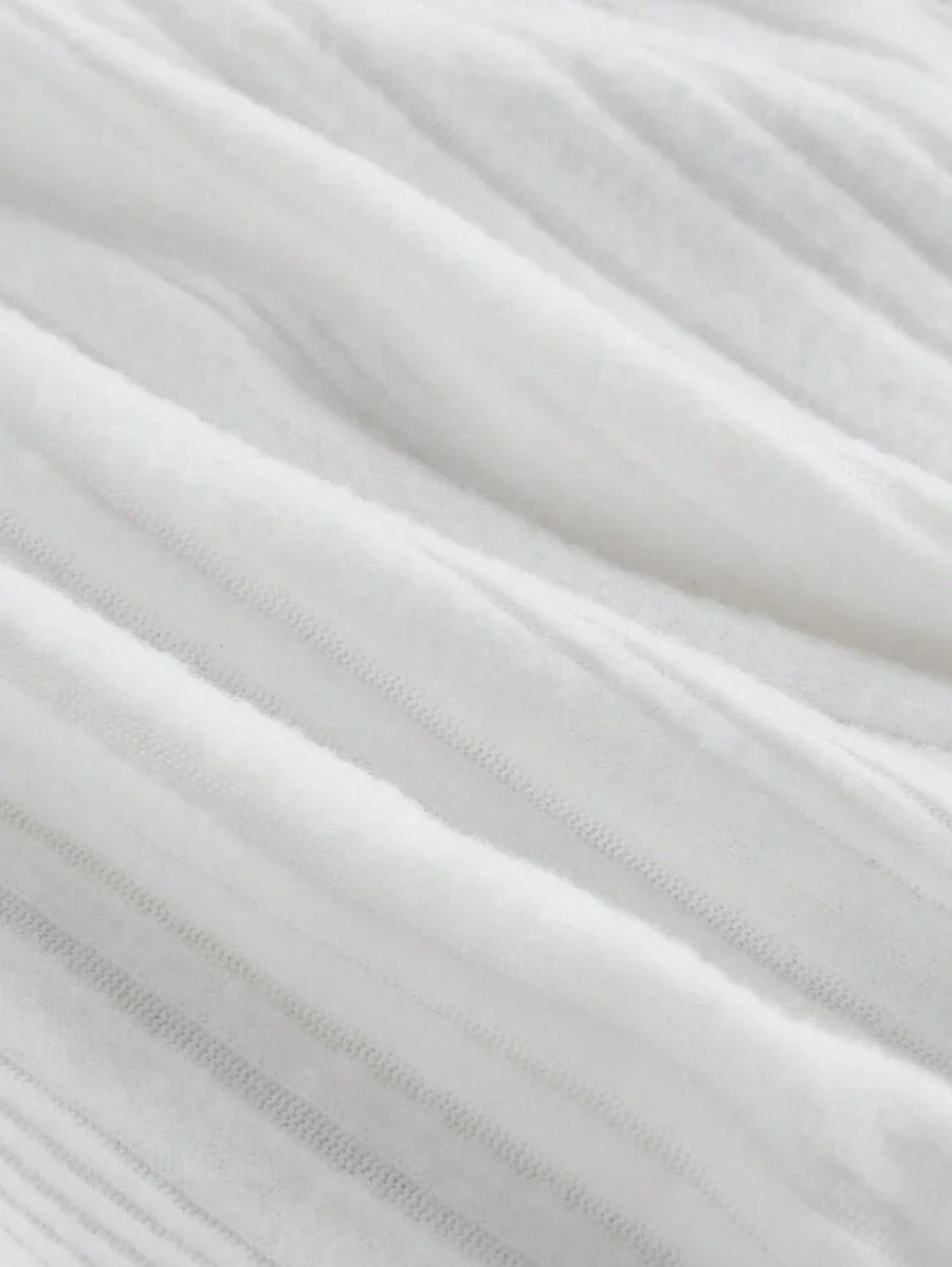 White ribbed knit dress with contrast trim, gold button accents, flared sleeves, and a tailored fit for a sophisticated and modern look