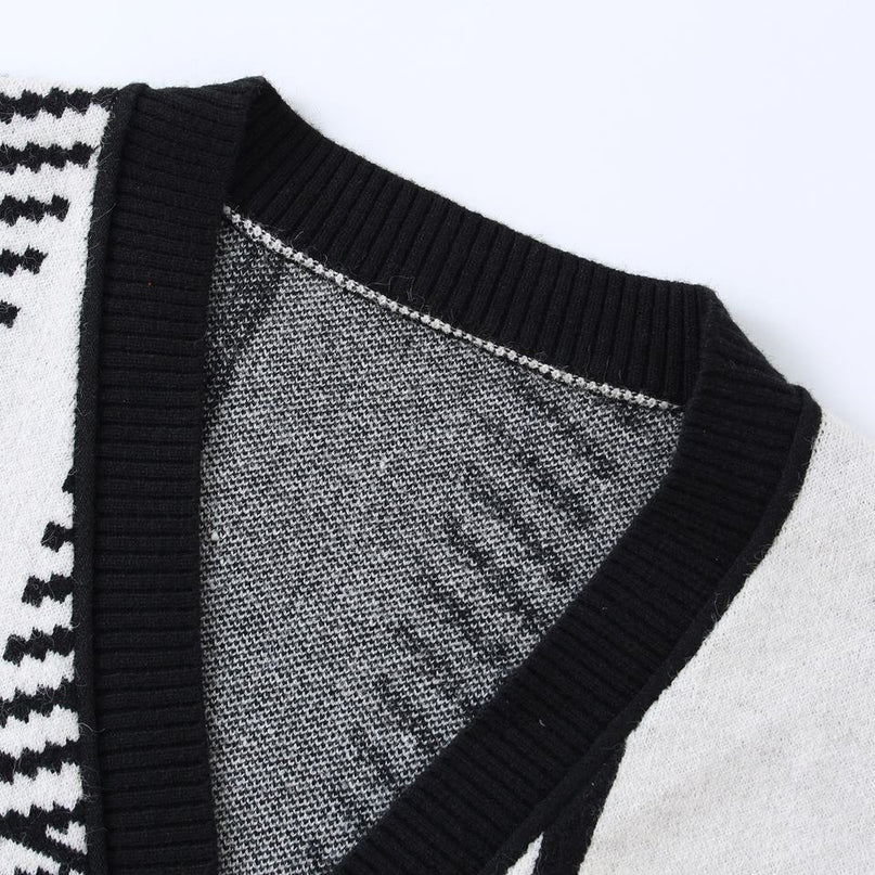 Jane wearing black and white plaid cardigan sweater with V-neckline and full sleeves