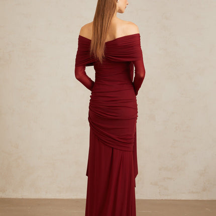 Jane wearing Red Juniper Twilight Sonata Gown with off-the-shoulder silhouette, long sleeves, front tie detail, pleated, asymmetrical, and ruched detailing, draped accents, slip-on style, floor-length hem, made from 83% cotton and 17% spandex