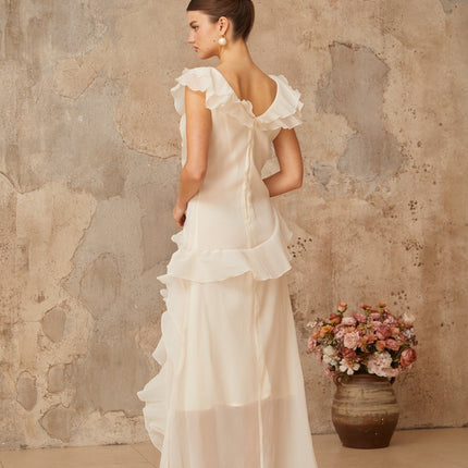 Jocelyn Maxi Dress in Neutrals Terylene Fiber Ruffled Floral V-Neck Cap Sleeves Cinched Waist Faux-Flower Detailing Asymmetrical Hem Rear Zip Tie Fastening