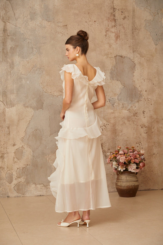 Jocelyn Maxi Dress in Neutrals Terylene Fiber Ruffled Floral V-Neck Cap Sleeves Cinched Waist Faux-Flower Detailing Asymmetrical Hem Rear Zip Tie Fastening