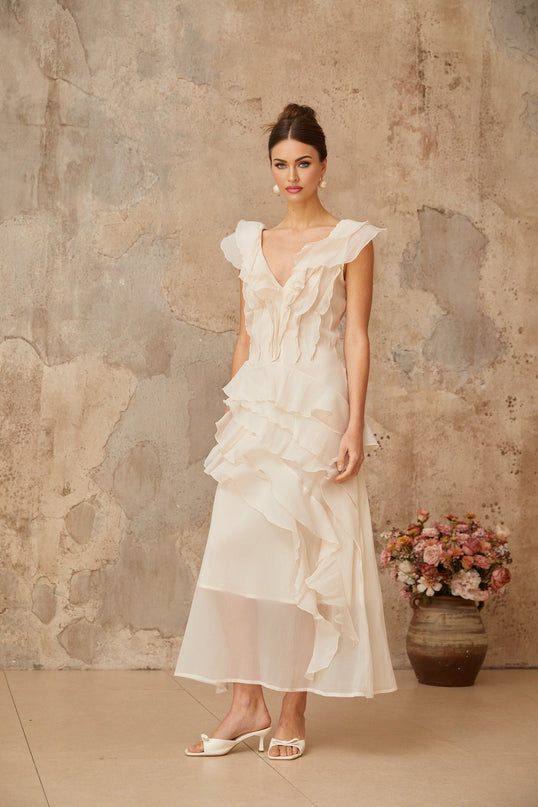Jocelyn Maxi Dress Neutrals Ruffled Floral Elegance V-neck Cap Sleeves Cinched Waist Faux-Flower Detailing Asymmetrical Hem Rear Zip Tie Fastening