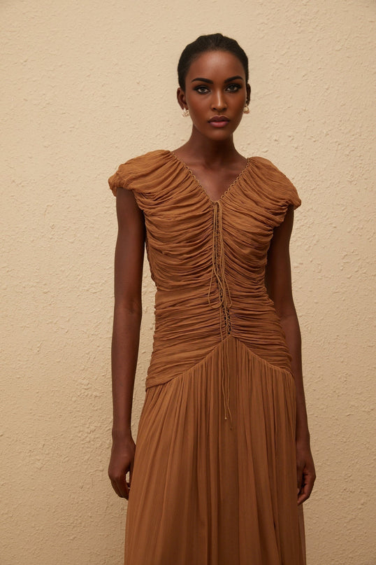Julia Maxi Dress in luxurious Brown Chiffon V-neck Ruched Detailing Pleated Skirt Drawstring Neckline Cap Sleeves Fitted Waistline 100% Viscose Sophisticated Elegant Comfortable Rear Zip Fastening High-end Fashion Timeless Allure