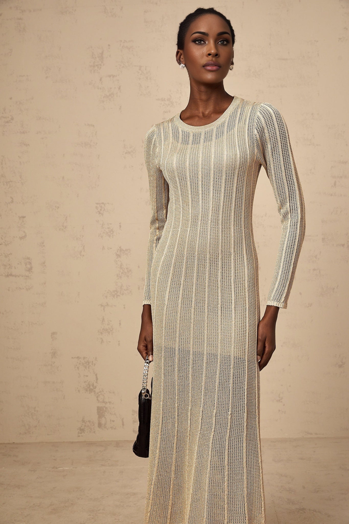 Khaki colored fitted knit midi dress on a plain background
