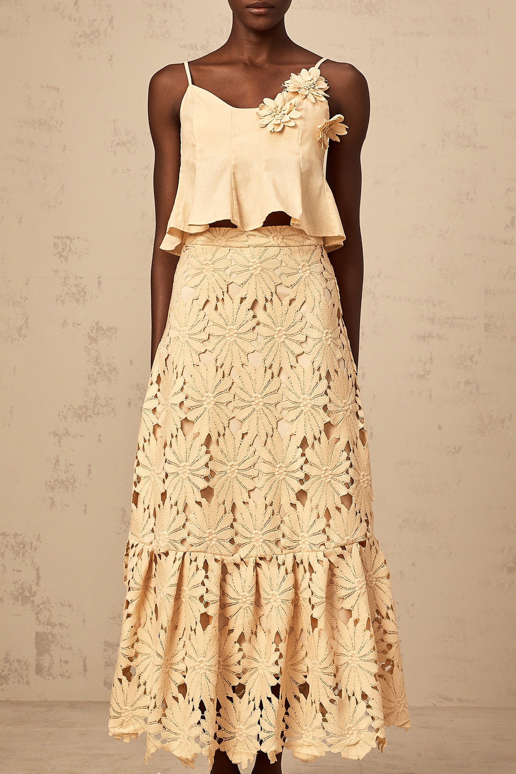 Khaki colored matching set with a flared top and skirt featuring cutout details
