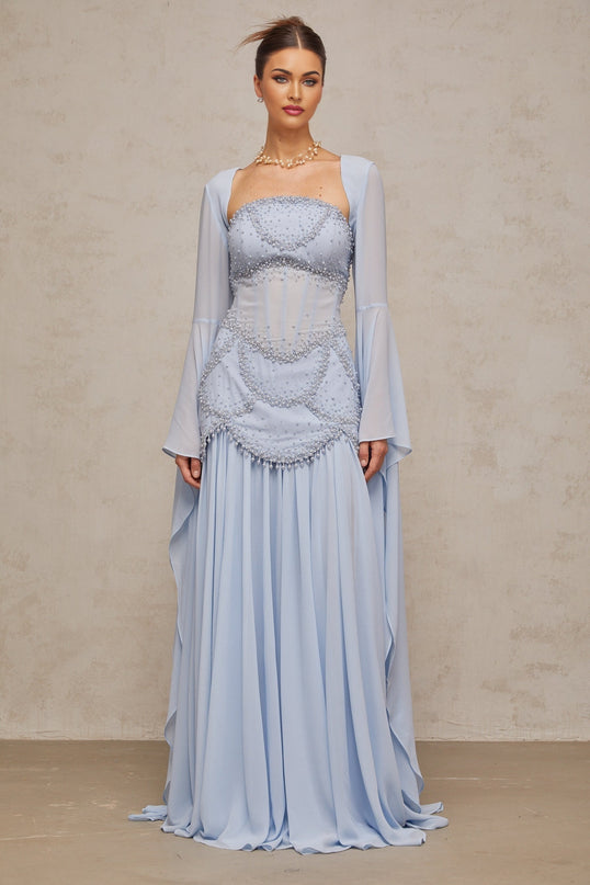 Light blue pleated maxi dress with faux pearl embellishments by Gaelle