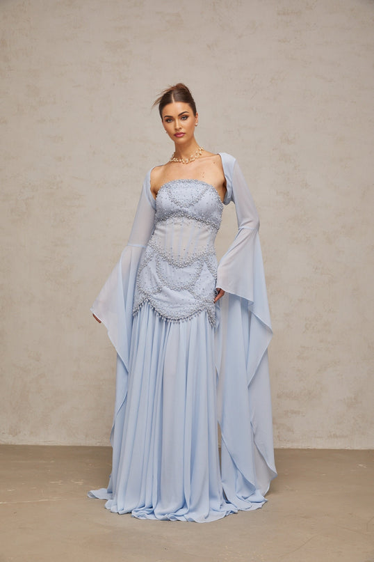 Light blue pleated maxi dress with faux pearl embellishments by Gaelle