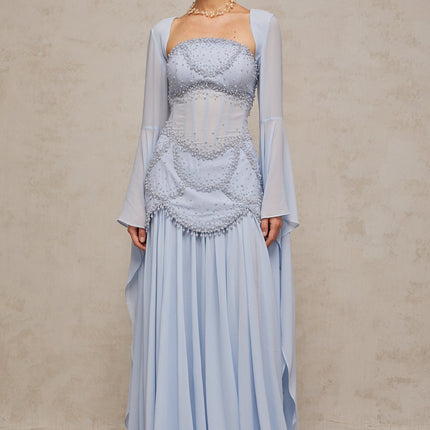 Light blue pleated maxi dress with faux pearl embellishments by Gaelle