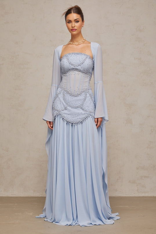 Light blue pleated maxi dress with faux pearl embellishments by Gaelle