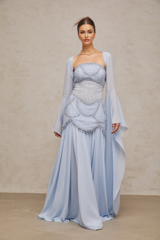 Light blue pleated maxi dress with faux pearl embellishments by Gaelle