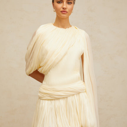 Lina Mini Dress in Neutrals Pleated Design with Ribbon Detailing and Glitter Accents Asymmetrical Silhouette Cinched Waist Bubble Hem Round Neck Twist Detailing Rear Zip Fastening Luxurious Blend of Terylene Viscose and Spandex