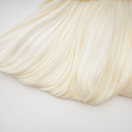 Lina Mini Dress in Neutrals pleated design with ribbon detailing and glitter accents