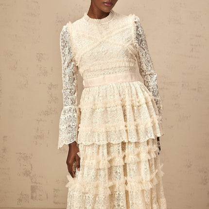 Long flowy maxi dress in neutral tones with lace panels and ruffled tulle details