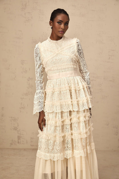 Long flowy maxi dress in neutral tones with lace panels and ruffled tulle details