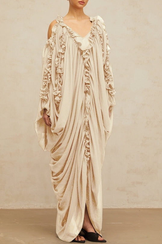 Long white tulle maxi dress with ruffled trim and delicate lace details