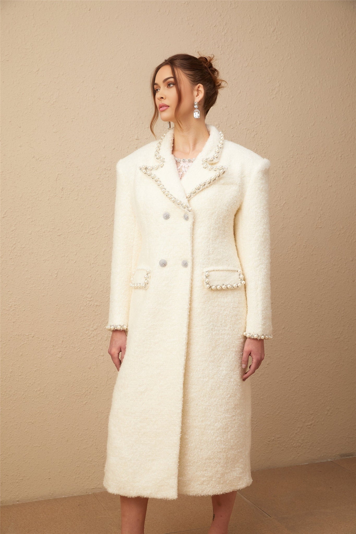 Long wool tweed coat with faux pearl embellishments by Isotta