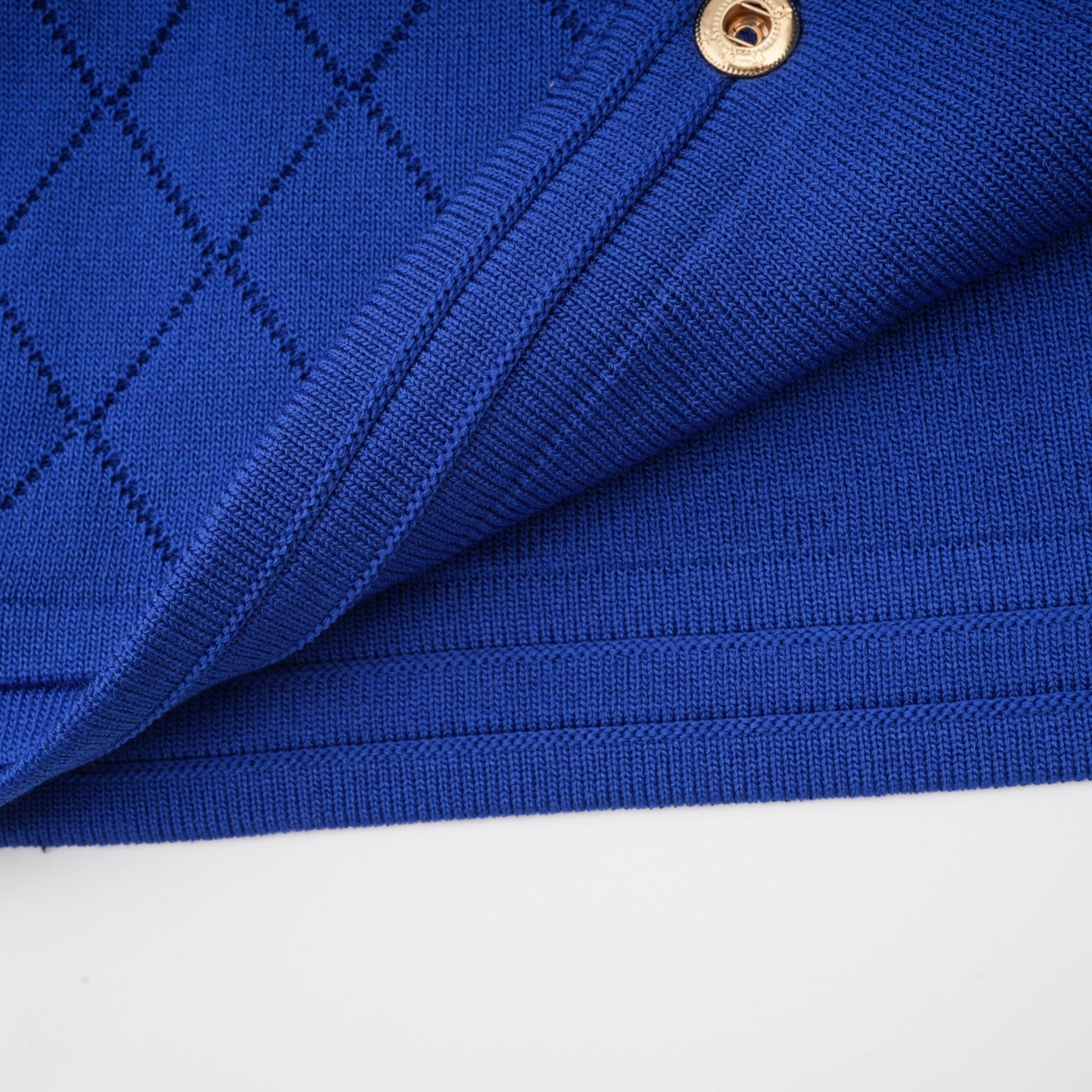 Maelys matching blue knitted set featuring a top with button details and a skirt