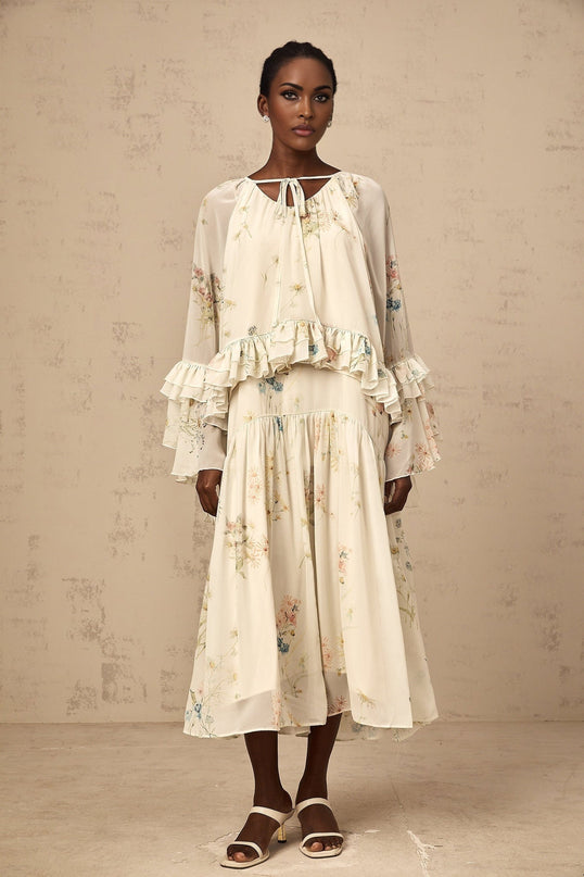 Matching set featuring a floral print blouse with ruffles and a coordinating dress in the same pattern