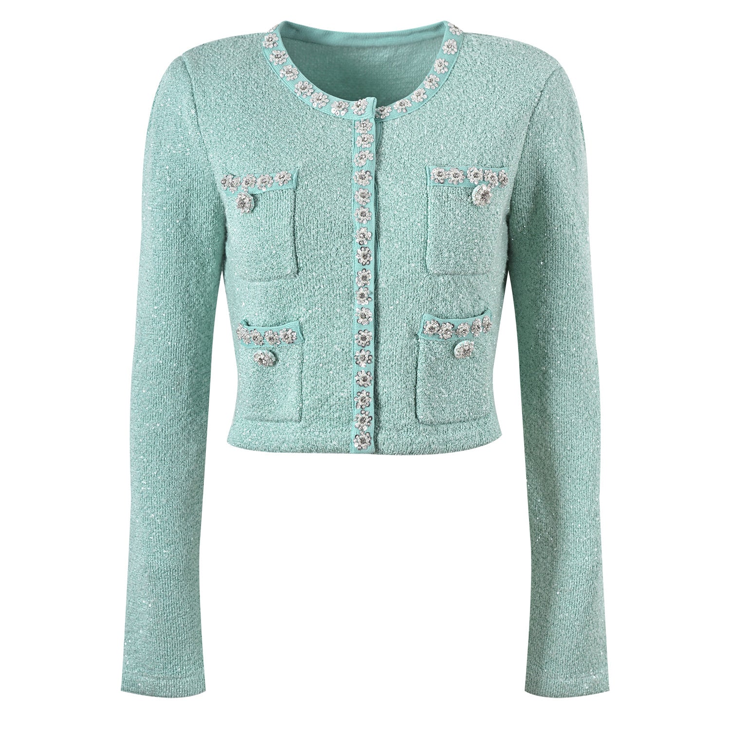 Mint green tweed jacket with floral embellishments paired with a pleated skirt, creating a chic and elegant look