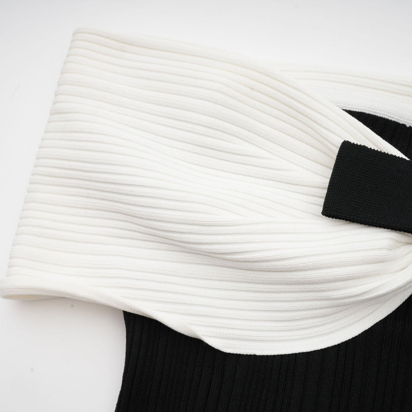 Miracle Mini Dress in Black & White off-shoulder design with crystal bow accent, thigh-length with contrasting colors and crystal embellishments, model 5'10" wearing size M, knitted construction blend of Viscose, Terylene, Nylon, and Elastane