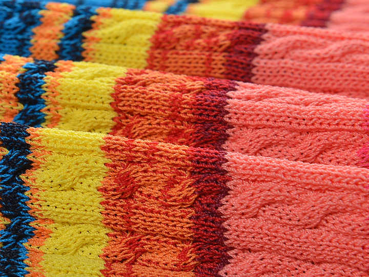 Multicolor striped bodycon dress in bright reds, greens, yellows, and blues for summer wear