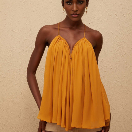 Embrace elegance in the Nemesis Ginger Pleated Chiffon Top Orange color
