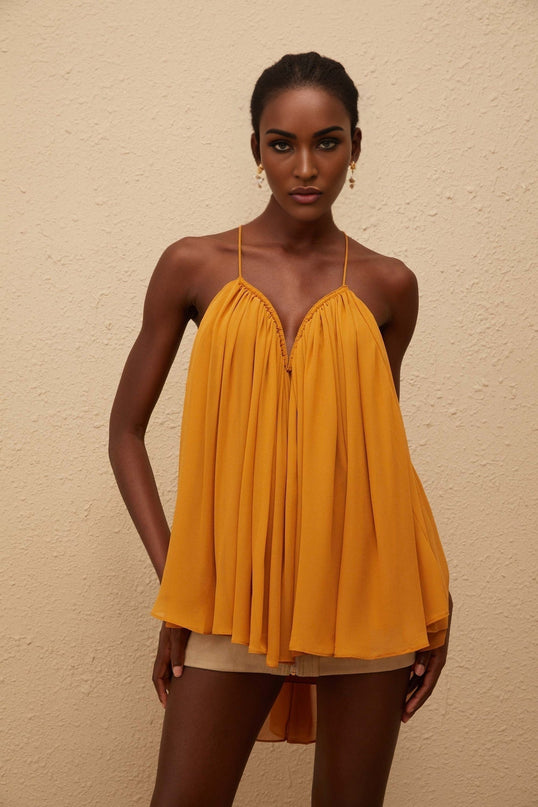 Embrace elegance in the Nemesis Ginger Pleated Chiffon Top Orange color