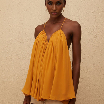 Alice wearing Nemesis Ginger Pleated Chiffon Top in Orange color