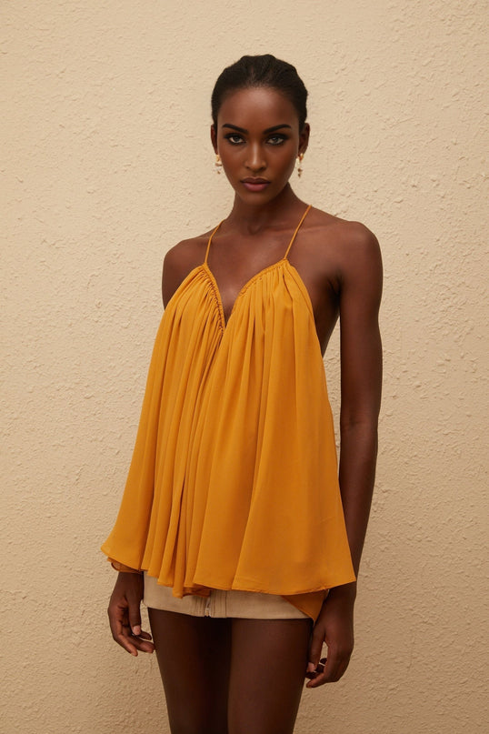 Alice wearing Nemesis Ginger Pleated Chiffon Top in Orange color