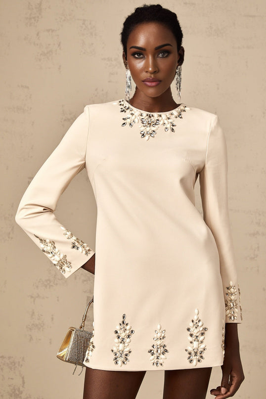 Neutral colored mini dress with long sleeves and crystal embellishments